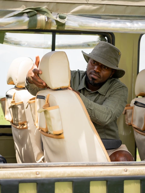 A guide adjusting a passenger headrest